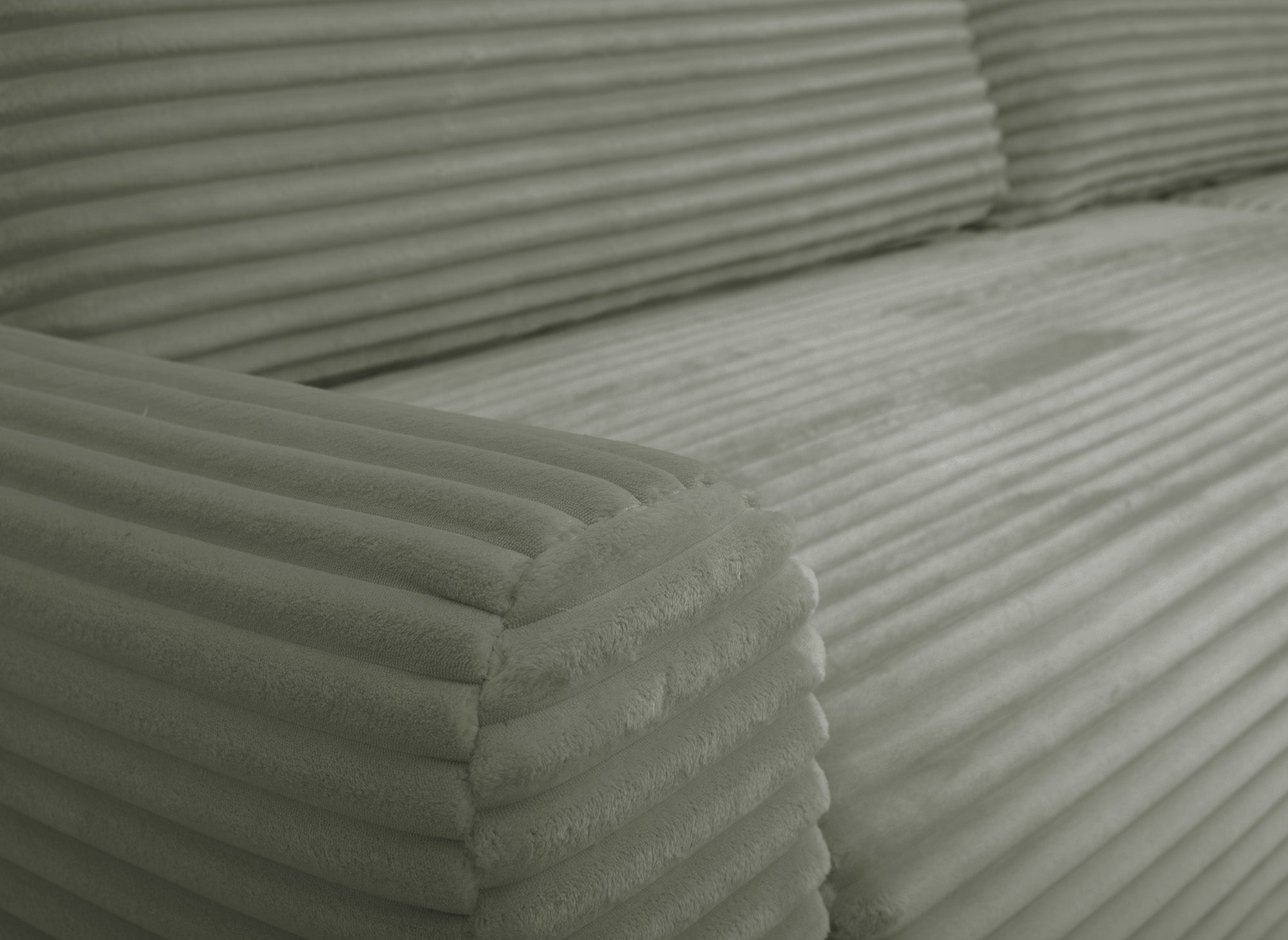 Sofá esquinero reversible y convertible KATIA con almacenaje en pana gruesa verde caqui.